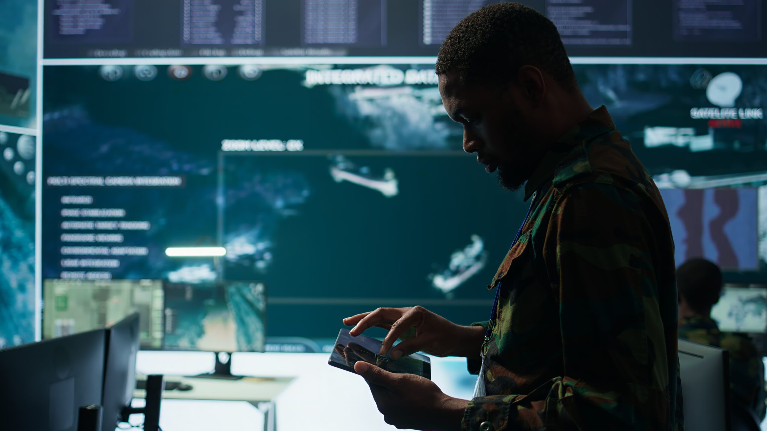 Cybersecurity specialist operates in a high tech military control center